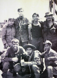 John Plaster ran two missions with Medal of Honor recipient Franklin D. Miller, top. Glenn Uemura stands beside Maj. Plaster and Chuck Hein kneels, front.